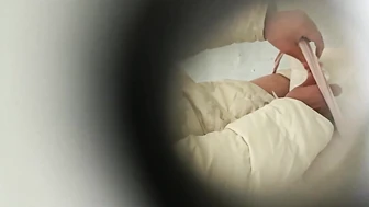 College Student Peeping Through a Hole